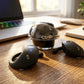 CTRL8 T2 over-the-ear earbuds with UNBLOQ technology and sleek design on a wooden desk